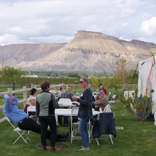 Attendees enjoying annual picnic with Mount Garfield backdrop